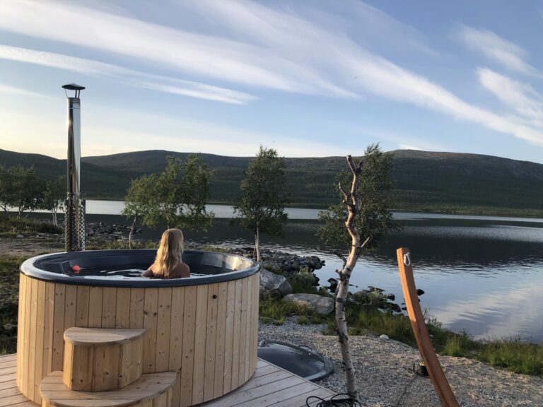 hot tub beside lake in kilpisjärvi lapland summer glass igloos finland